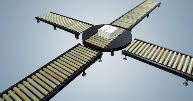 Four-way idler roller conveyor junction with central turn table manufactured by Unique Products